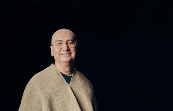 portrait of Rafael Fajardo wearing his grandfather's _ruana_ a monochomatic, short, wool, poncho from the highlands of Colombia